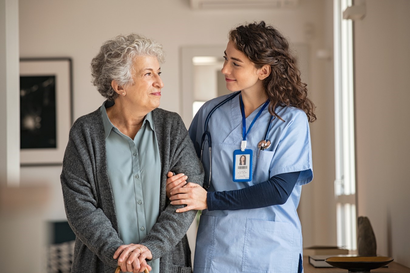 nurse helping old woman