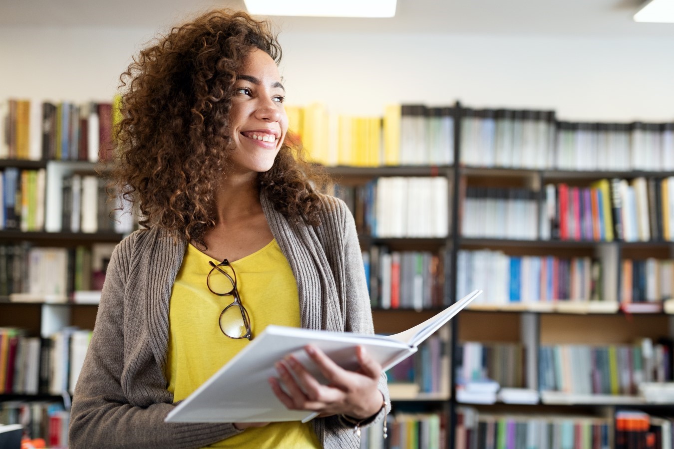 woman with book in library