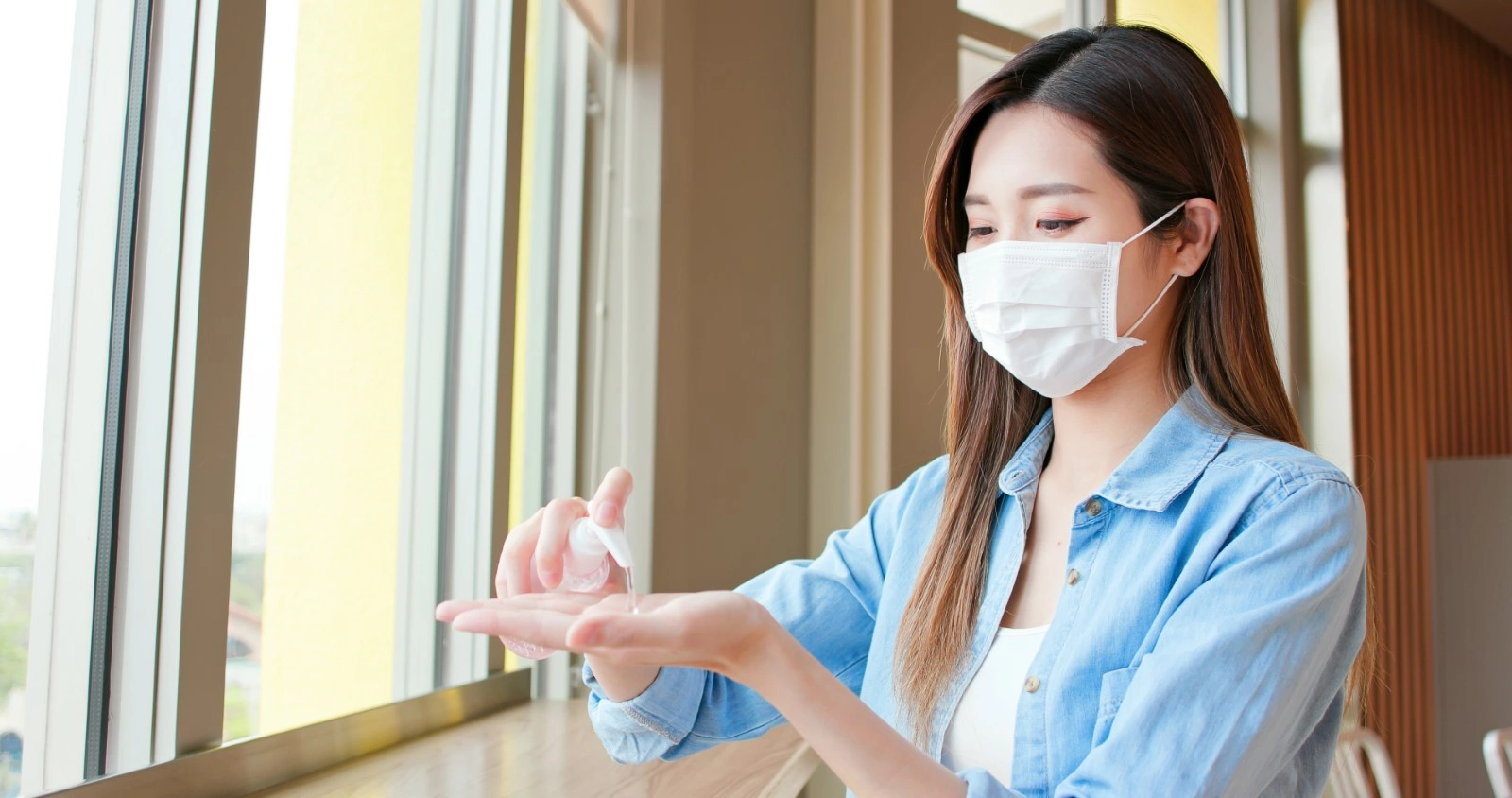 asian using hand sanitizer