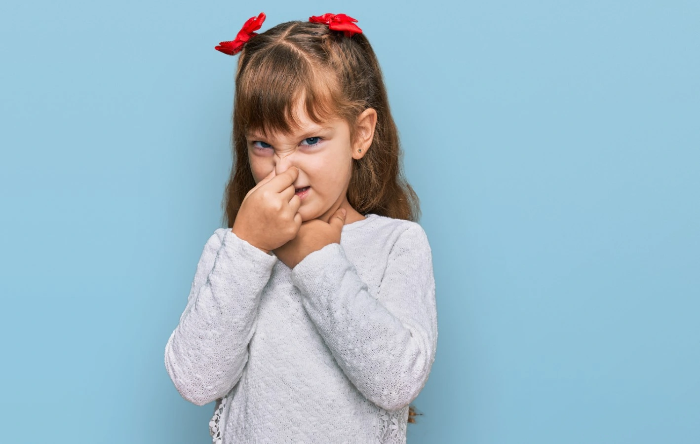 kid smelling something stinky