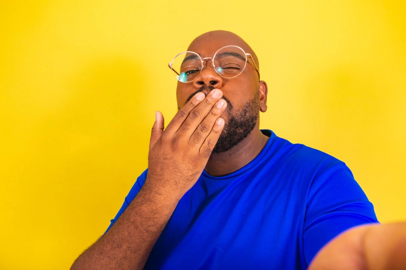 man blowing kiss