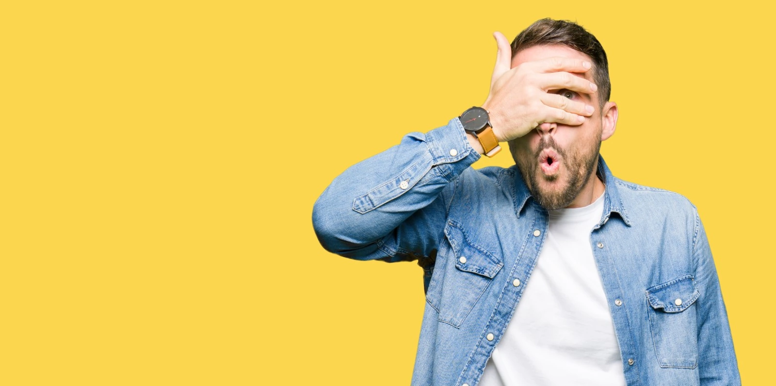 man covering his eyes