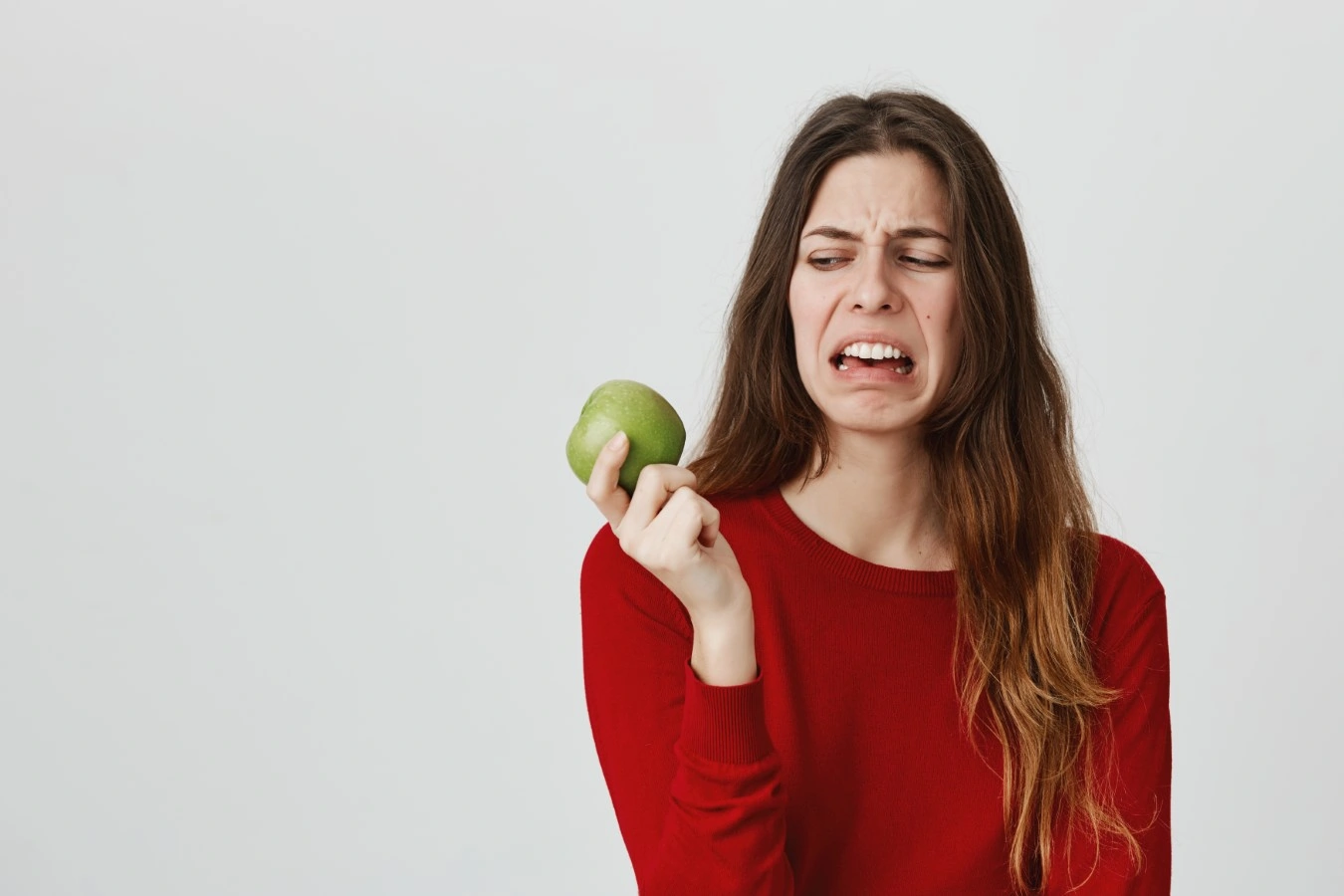 woman looking at apple